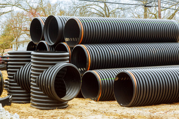 Under construction of housing of stacked plastic pipes on building