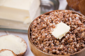 Buckwheat porridge with a piece of butter close up