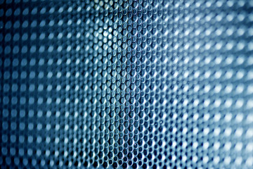 metallic mesh on a blue background. Whole background.