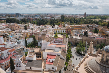Aerial view of the Cathedral of Saint Mary of the See (Seville Cathedral) in Seville, Andalusia, Spain in a sunny and cloudy day.
