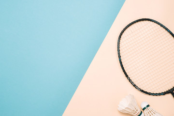 Shuttlecock and racket for playing badminton on a pástel color background. Minimalism. Concept summer razlecheny