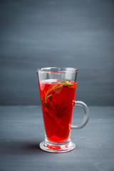Hot raspberry beverage with rosemary. Selective focus. Shallow depth of field. 