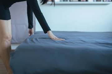 Close up of hands women making her bed in room after wake up,Female make a bed