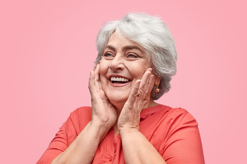 Excited elderly woman looking away