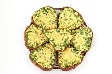 Hot sandwiches with wild garlic, green onions, eggs, cheese and parsley located on white background