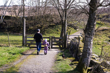 Father and child for a walk the spring season. Concept: walking with children, father and child, active lifestyle, leisure with children in Norway, outdoor activities with children.