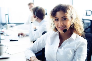 Female customer support operator with headset and smiling
