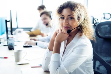 Female customer support operator with headset and smiling