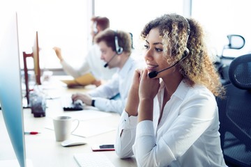 Female customer support operator with headset and smiling