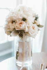 bridal bouquet in a glass vase with white roses
