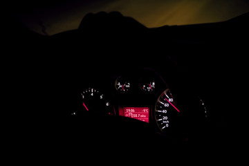 Night car driving. Hands on the wheel, dashboard
