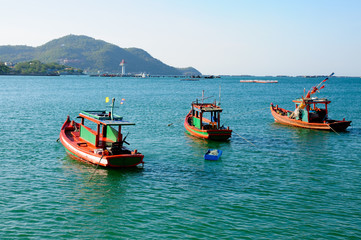 Fototapeta premium Three fishing boats at Asdang pier at Koh Sichang island, Chonburi, Thailand.