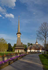 Fototapeta na wymiar Traditional Maramures wooden church and monastic cells building in Sapanta-Peri monastery, Romania