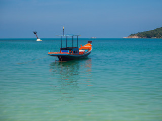 Naklejka na ściany i meble Motor boat on the surface of the sea near the island. Koh Phangan. Thailand