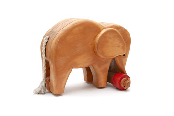 Wooden elephant with red wheels and tail