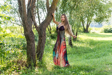 Obraz na płótnie Canvas Beautiful model dressed in fashionable dress posing outdoors