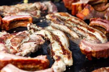 Frying pork meat on grill