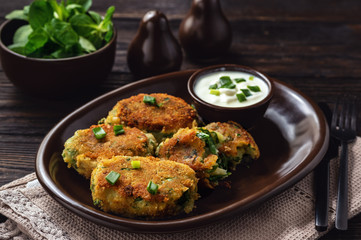 Homemade potato and spinach croquettes with yogurt dip.