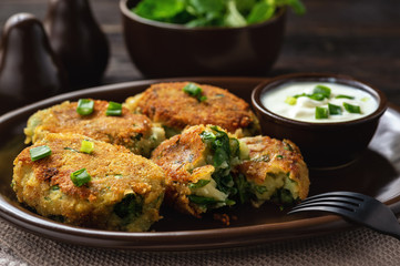 Homemade potato and spinach croquettes with yogurt dip.