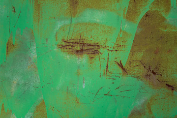 old dirty green metal wall shield with stains of paint, scratches and dots of brown rust. rough surface texture