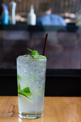 Cocktail with lemon and ice in a shop.