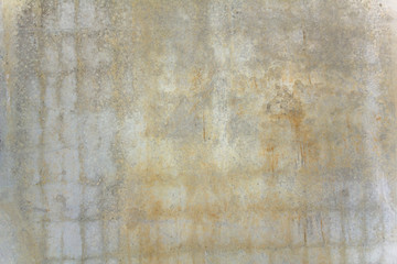old concrete wall with white and yellow spots of paint and scratches. rough surface texture