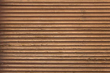 old gray brown beige wavy wooden surface with peeling paint and horizontal lines with shadows. rough texture