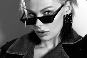 beautiful woman with short blond hair in elegant clothes with fashion sunglasses