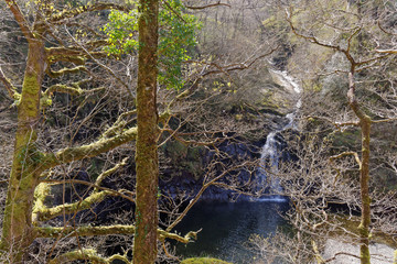 View of a waterfall on a tourist trail in the mountains of Snowdonia, Wales.