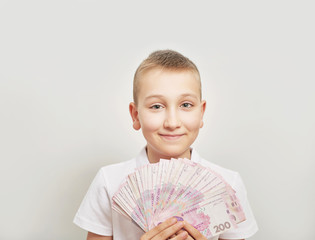 boy with money hryvnia on white background
