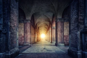 Wall murals Old building Rays of divine light illuminate old arches and columns of ancient buildings. Bologna, Italy. Conceptual image on historical, religious and travel theme.