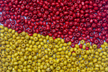 abstract background beautiful top view red and yellow colors small wooden beads