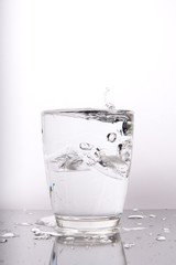 glass of water with ice on white background