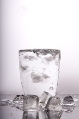 glass of water with ice on white background
