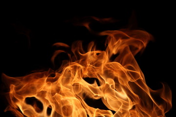 Fire burning on dark background for abstract flame texture and graphic design purpose