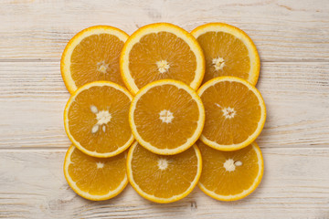 slices of fresh oranges on white wooden background, top view. Space for text
