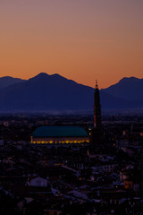 wide panorama during the sunset of the city of Vicenza and the famous monument called Basilica Palladiana with the tall Clock Tower. Vicenza, Veneto, Italy - April 2019