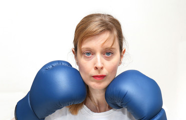 Blue boxing gloves near face