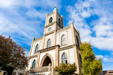 Fototapeta na wymiar View of the Christian Church with a cross and a bell tower.