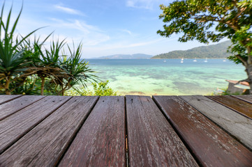 Fototapeta na wymiar Wooden tabletop on tropical sea in summer
