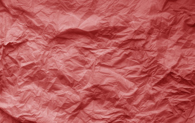 Fototapeta premium Crumpled sheet of paper in red color.