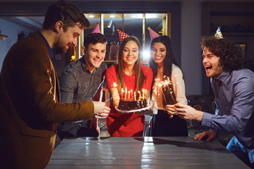 Friends celebrating birthday party indoors