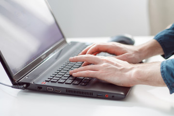 hands on the laptop keyboard close-up