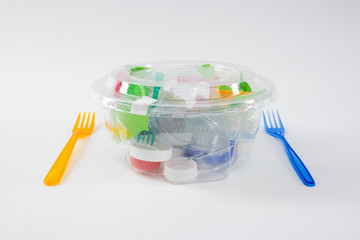 Harmful pile of plastic trash and pieces placed inside of transparent container