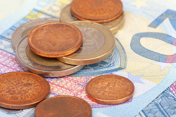 Micro loan offer. Little bit of European Union money. Metal coins of and paper banknotes design. Euro cash closeup on white background. Limited depth of field