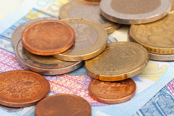 Micro loan offer. Little bit of European Union money. Metal coins of and paper banknotes design. Euro cash closeup on white background. Limited depth of field