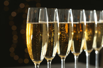 Many glasses of champagne on blurred background, closeup © New Africa