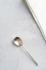 Vintage tea spoon on grey background. Top view