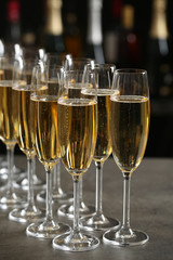 Glasses of champagne on table against blurred background