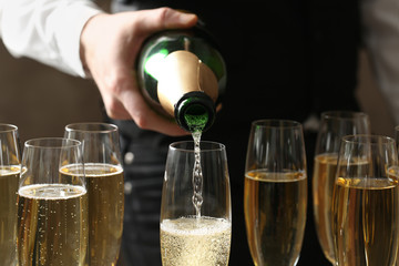 Waiter pouring champagne into glass, closeup view © New Africa